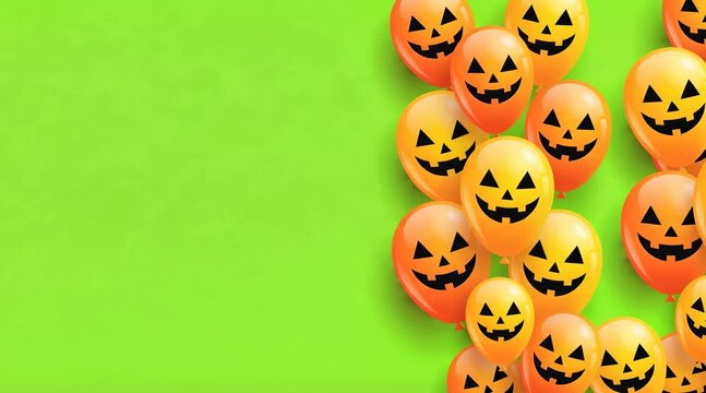 Halloween balloons with jack-o-lantern faces arranged on bright green background for festive design  
