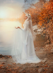 art photo real person, faerie fantasy woman walking by river lake water nature magic sun light flare. sexy fairy tale elf girl long blonde hair white dress back. snow queen crown deer antlers on head.