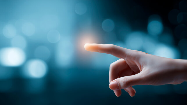 A woman's hand touching with her finger while emitting light, a concept of virtual reality in modern technology