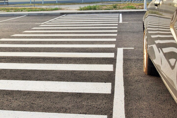 Traffic management. A car is parked near a pedestrian crossing.
