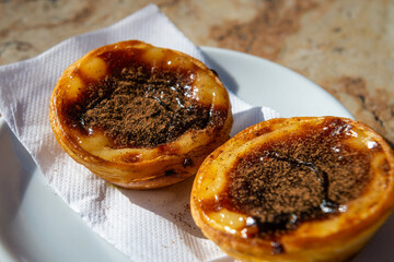 Traditional Portuguese breakfast snack of Pastel de Nata (custard tart)  on a marble counter