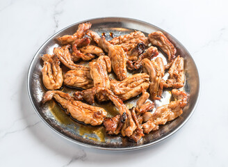 Savory chicken gizzards sizzling on a metal plate, ready to eat for dinner or lunch, a delicious traditional meal for foodies