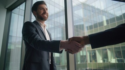 Caucasian businessman smiling business man shaking hands with African male partner in modern office handshake greeting cooperation success teamwork deal partnership agreement multicultural meeting - Powered by Adobe