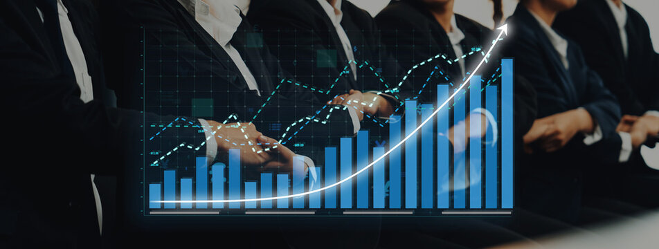 Business professionals engaged in a financial presentation, featuring growth charts and data analysis in a modern and collaborative environment. Axiom