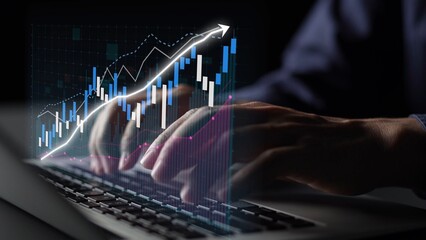 Close-up of hands typing on a laptop with a digital financial chart illustrating market trends, symbolizing technology-driven data analysis in finance. Copula