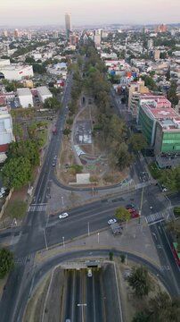 Aerial vertical shot advancing along linear park over Lazaro Cardenas Avenue in Guadalajara, Mexico