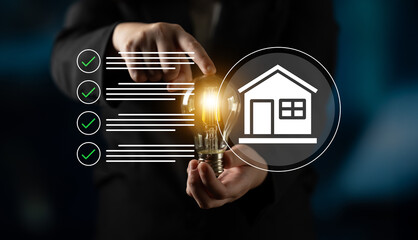 A businessman demonstrates innovation with a light bulb, representing smart home technology ideas,...