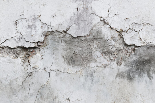 Aged white wall with visible cracks and peeling paint textures