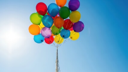 Vibrant multicolored balloons against a clear blue sky