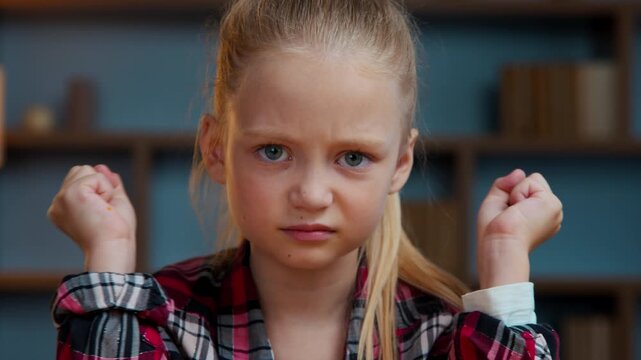 Portrait at home furious angry child kid girl little annoyed irritated daughter in evening home looking at camera stressed mad reaction bad news teen pupil feeling anger dissatisfied childhood problem