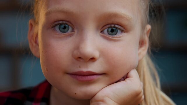 Extreme close up portrait Caucasian little cute child kid girl daughter looking at camera indoors at home look positive charming baby innocence childhood pediatric health childcare happy face emotion