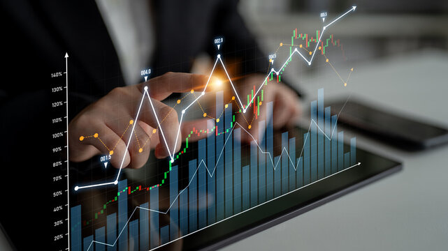 A finance professional uses a tablet to analyze stock market data, showcasing digital graphics and financial trends in a modern office setting. Scalp - Powered by Adobe