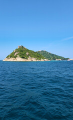Koh Nang Yuan Island seen from the sea with clear turquoise water and lush green hills, Surat Thani, Thailand, Southeast Asia.