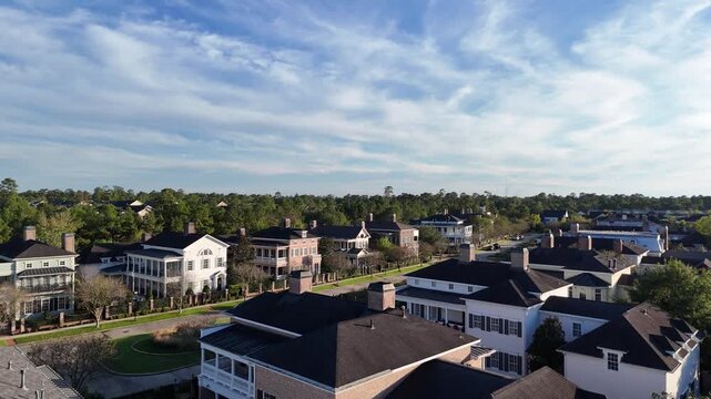 Large mansion houses with swimming pool, in affluent neighborhood metroplex, expensive suburban homes surrounding by lush green trees, aerial view, Texas, USA