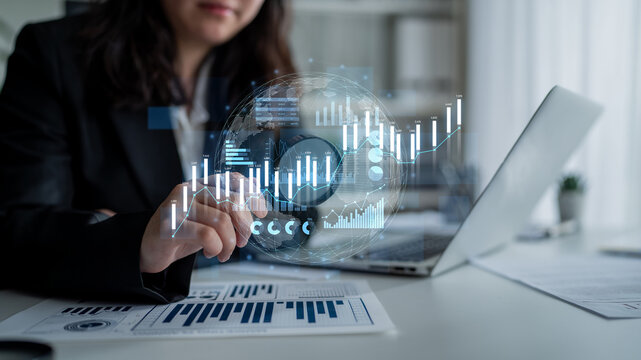 A business professional engaged in data analysis interacts with digital financial charts, illustrating trends and performance metrics in a modern office space. Scalp - Powered by Adobe