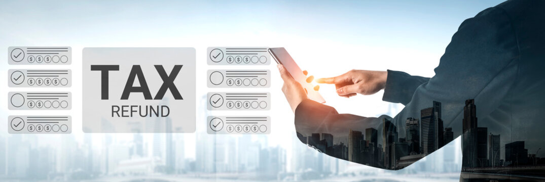 A businessman analyzes tax refund information on a tablet against an urban backdrop, showcasing the intersection of finance and technology during tax season. Gantry