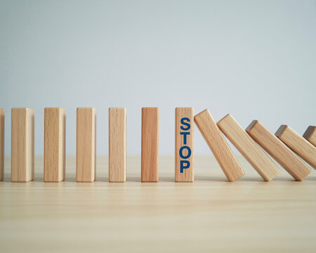 Preventing a chain reaction with a stop block, demonstrating risk management, crisis control, and strategic planning for business and finance success