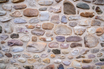 Photograph showcasing rugged limestone and granite wall with moss and shadow play for artistic projects