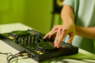 DJ setup overview, Energetic club DJ performing with digital controller in action, Content creator mixing music live using digital turntables under vibrant stage lights