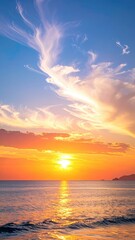 Vivid sunset paints the sky with gold & orange hues over calm ocean waves