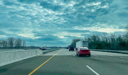 Rippled cloudy sky above vehicles traveling on multi-lane divided highway