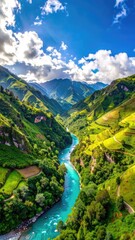 Fototapeta premium Stunning aerial view of a vibrant turquoise river winding through lush, terraced green mountains under a bright, cloudy sky.
