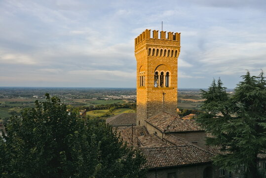 The crenellated medieval tower overlooking the plains and rooftops of the historic town of Bertinoro, Italy.