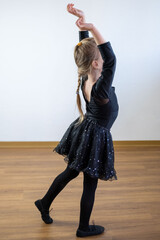 young girl in black dress performing ballet dance, dance performance, childhood memories, artistic expression and discipline © kittyfly