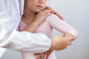ballerina in Ballet leotard with female professional, medic or instructor, compassionate interaction between presumed doctor and young girl, receiving attention, dance injury