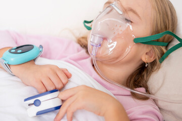 Young person, girl receiving oxygen therapy, Child lies with oxygen mask and pulse oximeter on finger, patient health tracker, pediatric respiratory care, recovery hospitalization, health monitoring