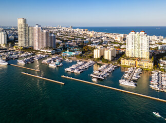 Obraz premium Miami marina with yachts and sailboats. Miami marina and turquoise ocean. Miami seascape aerial view on south beach shore. Luxury cruise ship in Miami harbor.