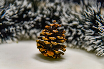 Pine cone and Christmas black and white tinsel for decoration.