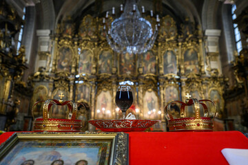  Two crowns, a cup of wine and a cross prepared for baptism