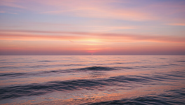 Vibrant pastel pink and purple sunset over tranquil ocean waves