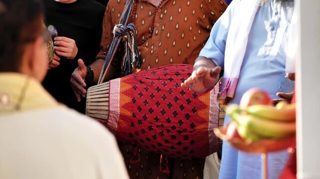 People celebrating Ganesha festival in India with traditional music and devotion