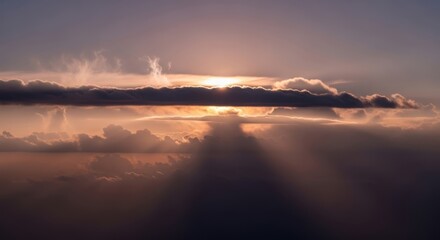 Golden sun peeking behind clouds, creating dramatic light rays