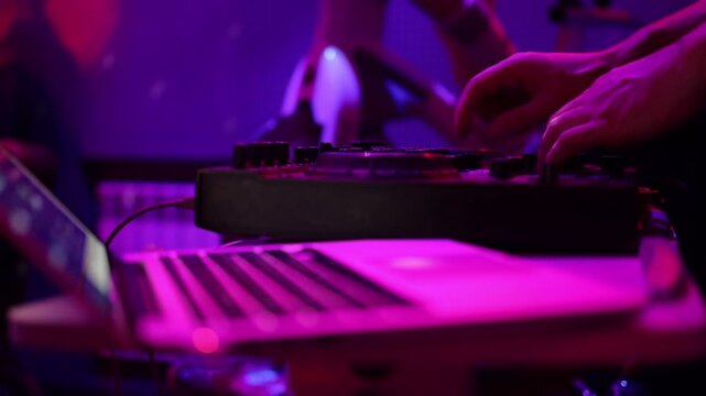 DJ setup overview, Energetic club DJ performing with digital controller in action, Content creator mixing music live using digital turntables under vibrant stage lights