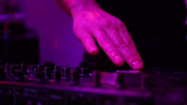 DJ setup overview, Energetic club DJ performing with digital controller in action, Content creator mixing music live using digital turntables under vibrant stage lights