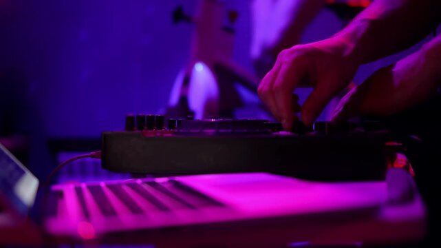 DJ setup overview, Energetic club DJ performing with digital controller in action, Content creator mixing music live using digital turntables under vibrant stage lights