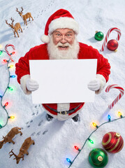 Joyful Santa's Message: jolly Santa Claus holds a blank sign, surrounded by festive decorations, spreading cheer for the season. A scene that embodies the spirit of joy and gift giving.