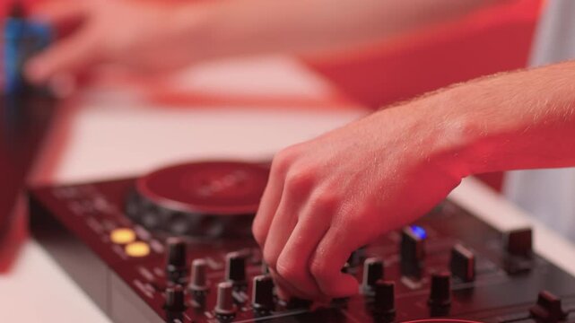 DJ setup overview, Energetic club DJ performing with digital controller in action, Content creator mixing music live using digital turntables under vibrant stage lights