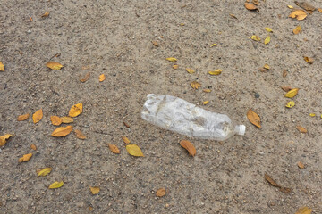 Trash left behind in a park area during autumn season shows the need for more cleanliness and awareness about littering