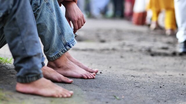 Barefoot devotees waiting for Ganesha festival celebration and procession in India