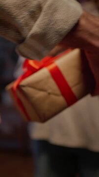 Boyfriend presenting gift box to girlfriend at evening time