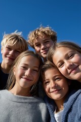 Obraz premium Smiling group of caucasian teens outdoors under clear blue sky