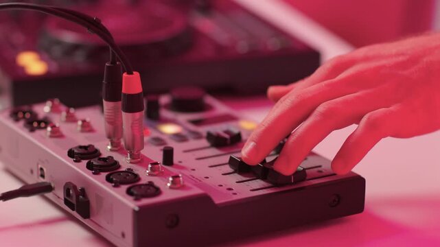 Closeup of tactile controls and vibrant patch cords in studio, Adjusting analog sequencing equipment with bright cables and warm ambient lighting in home studio