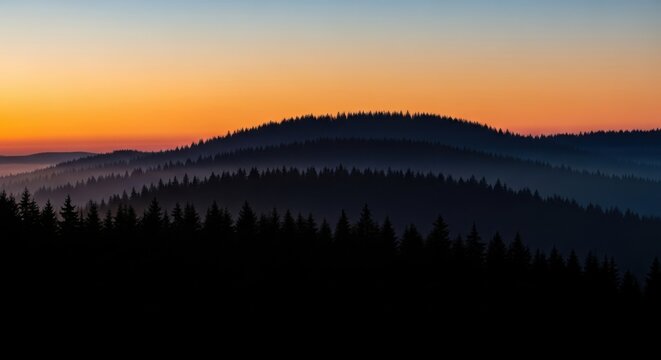 Misty mountain range bathed in golden sunrise light