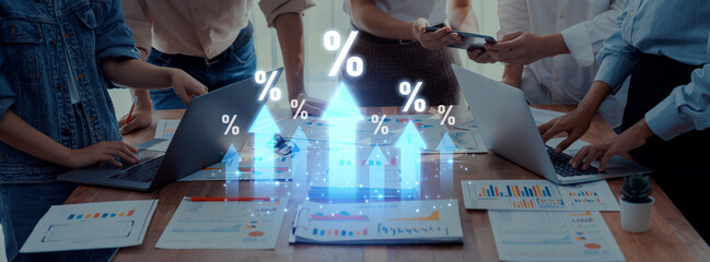 A diverse team engages in business strategy discussions, examining growth percentages and data...