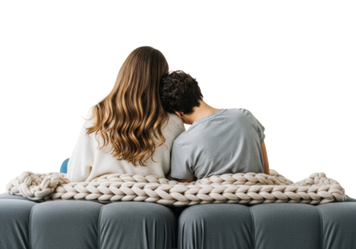 two young caucasian women sitting close on a grey sofa under a thick knit blanket, rear view, isolated against a seamless high-key white background with copy space, showcasing relationship intimacy