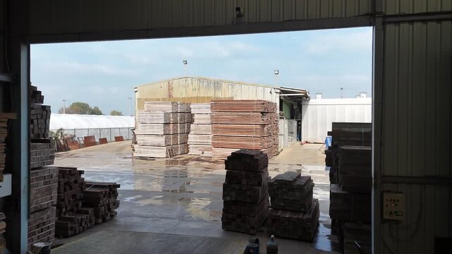 Industrial footage of a wood storage warehouse filled with stacked lumber and timber materials. Represents woodworking, construction supply, carpentry, and lumber industry logistics. Perfect for indus